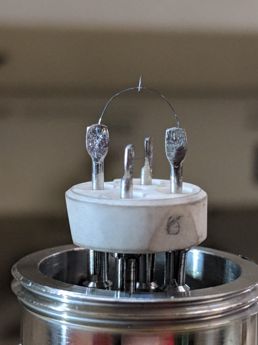 Milly is both the largest and smallest instrument in the shop: a couple of tons of steel, heaters, water pumps, high voltage supplies, and vacuum apparatus all boil down to carefully controlled microamps emitted from this tiny tip.